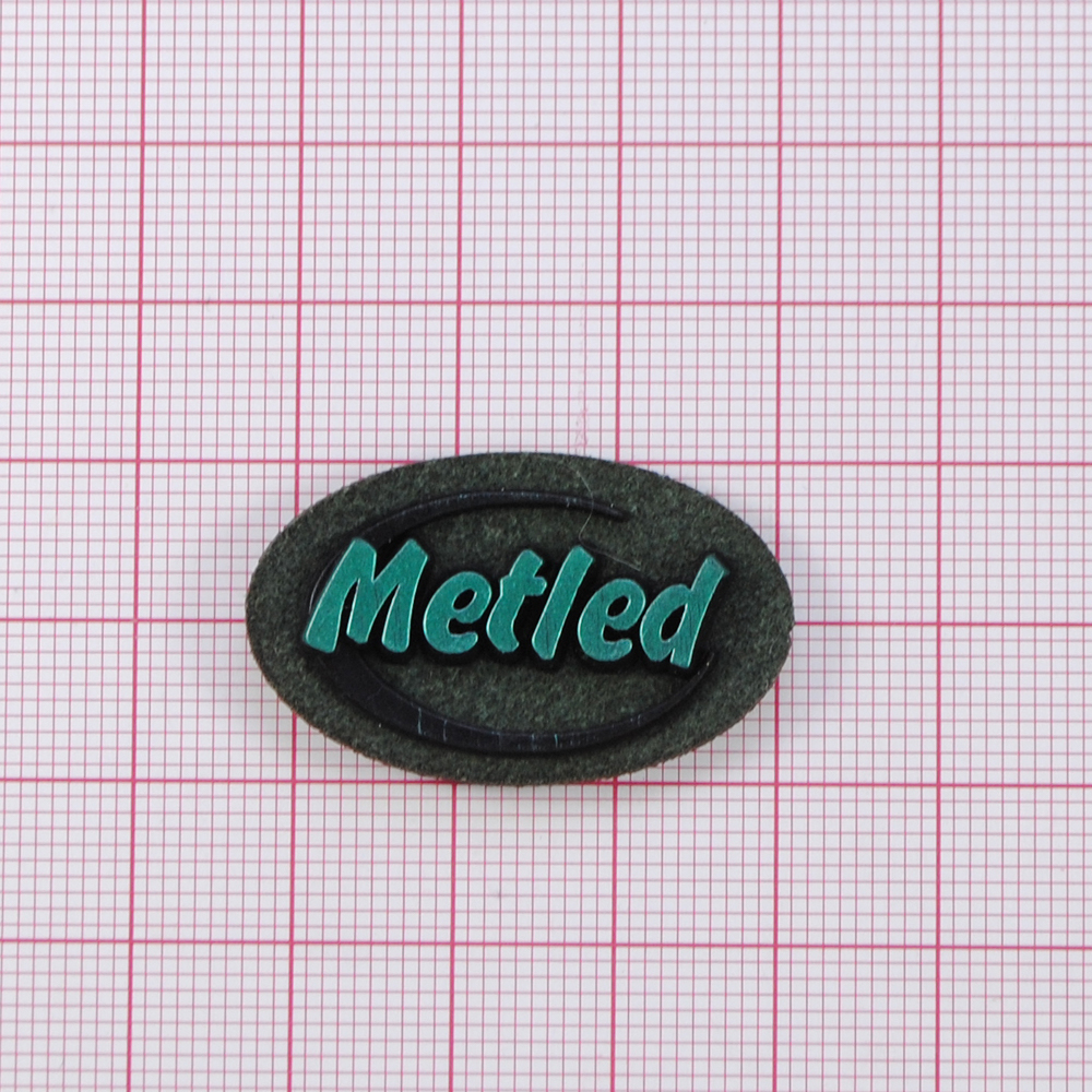 Лейба к/з Metled, 3,5*2см, овал, зеленый фон, напыление, шт. Лейба Кожзам