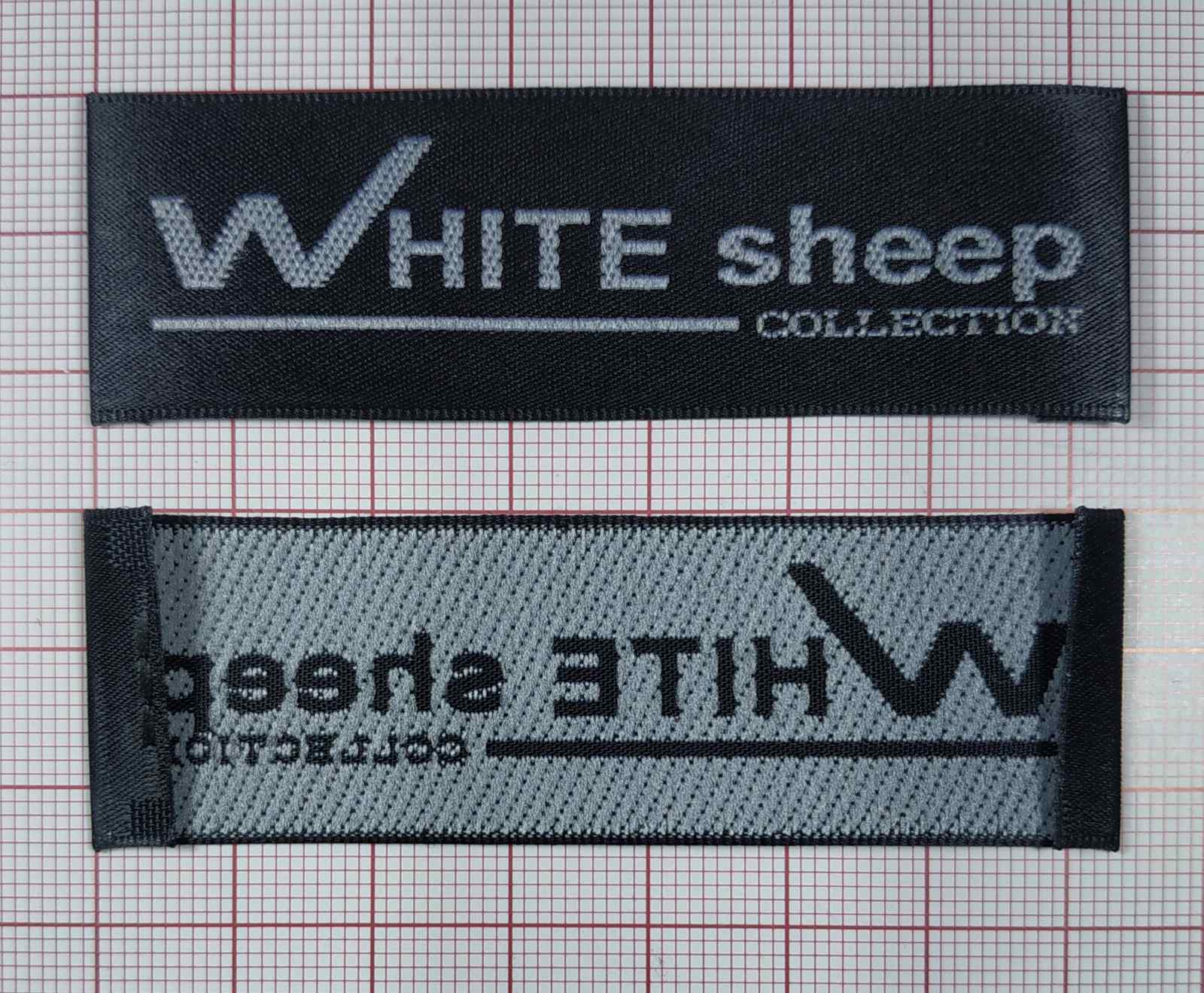 Вышивка штучная White Sheep 2,5*7,3см черная, белый лого /порезаный и заглаженный/, 1000 шт. Вышивка / этикетка тканевая