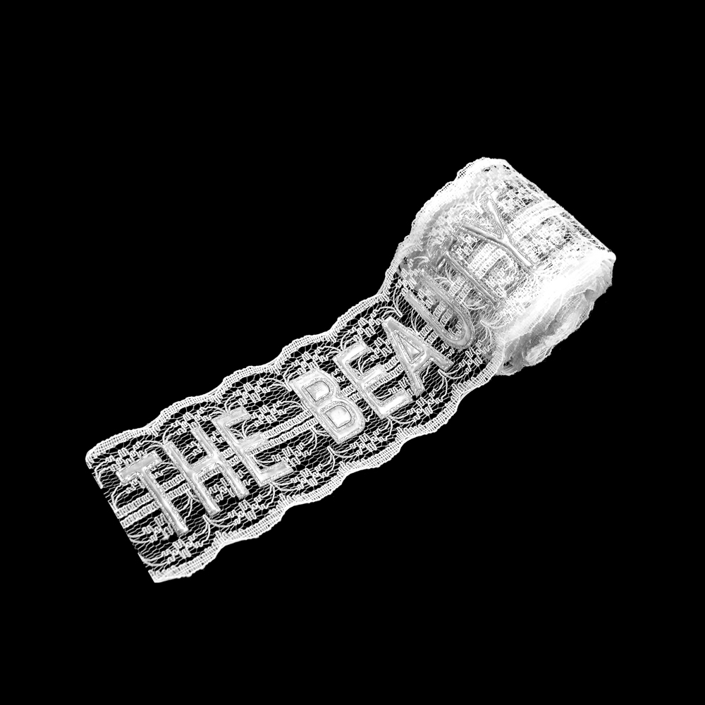 Тесьма кружевная с прорезиненным лого THE BEAUTY, 5см, белый, серебряный, ярд. Тесьма