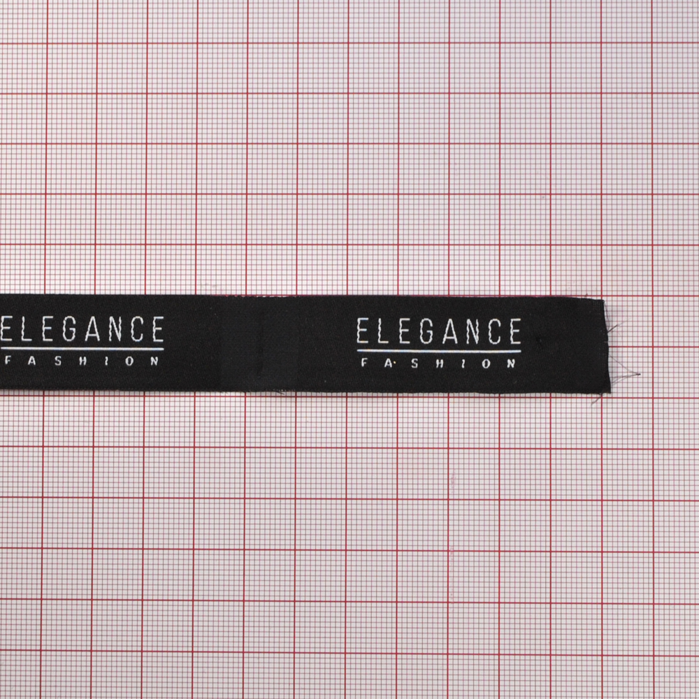 Этикетка тканевая вышитая Elegance №7, 2*6,5см, черная и белый лого /70 atki/, шт. Вышивка / этикетка тканевая
