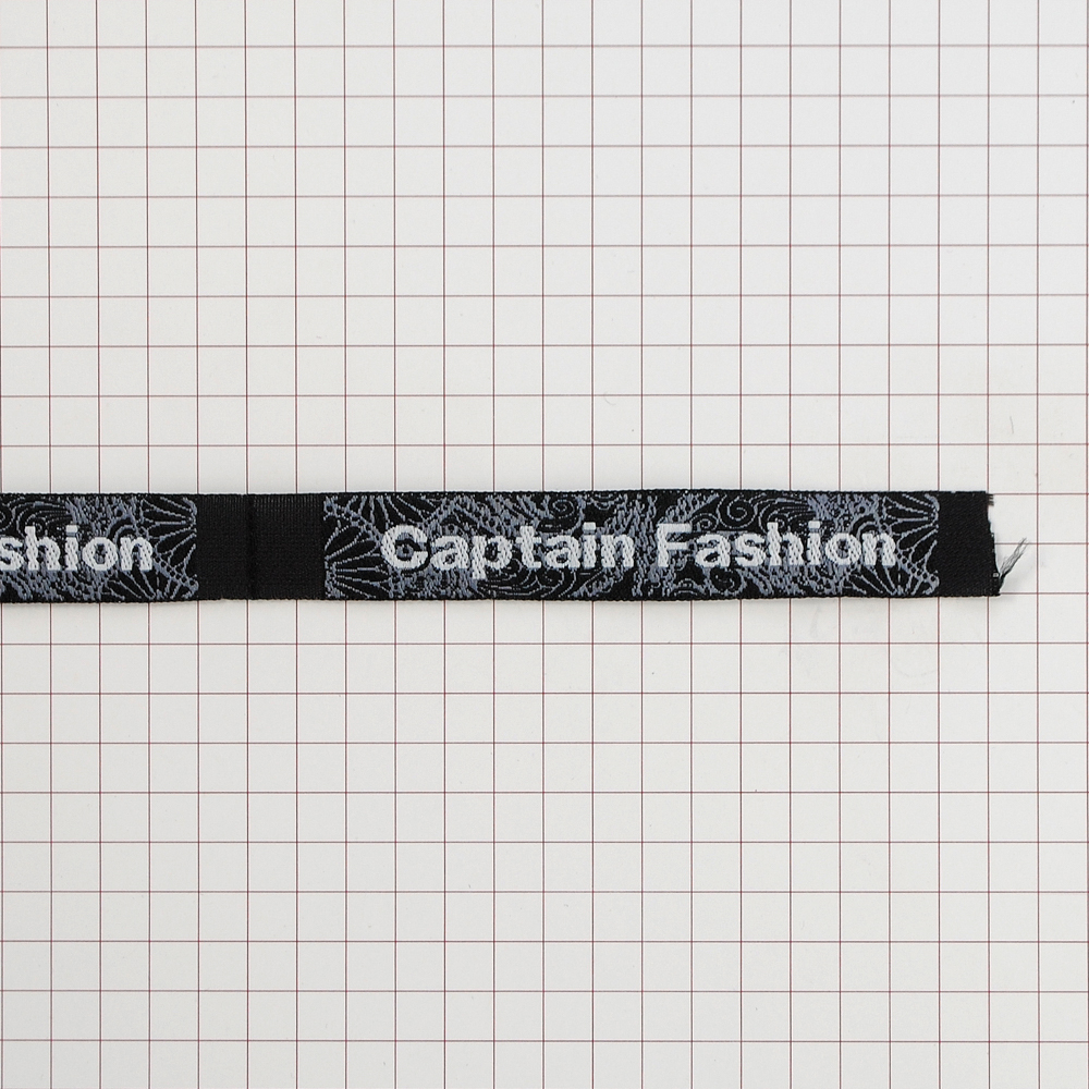 Этикетка тк.выш. Captain Fashion черная, серый узор /1.2 см/. Вышивка / этикетка тканевая