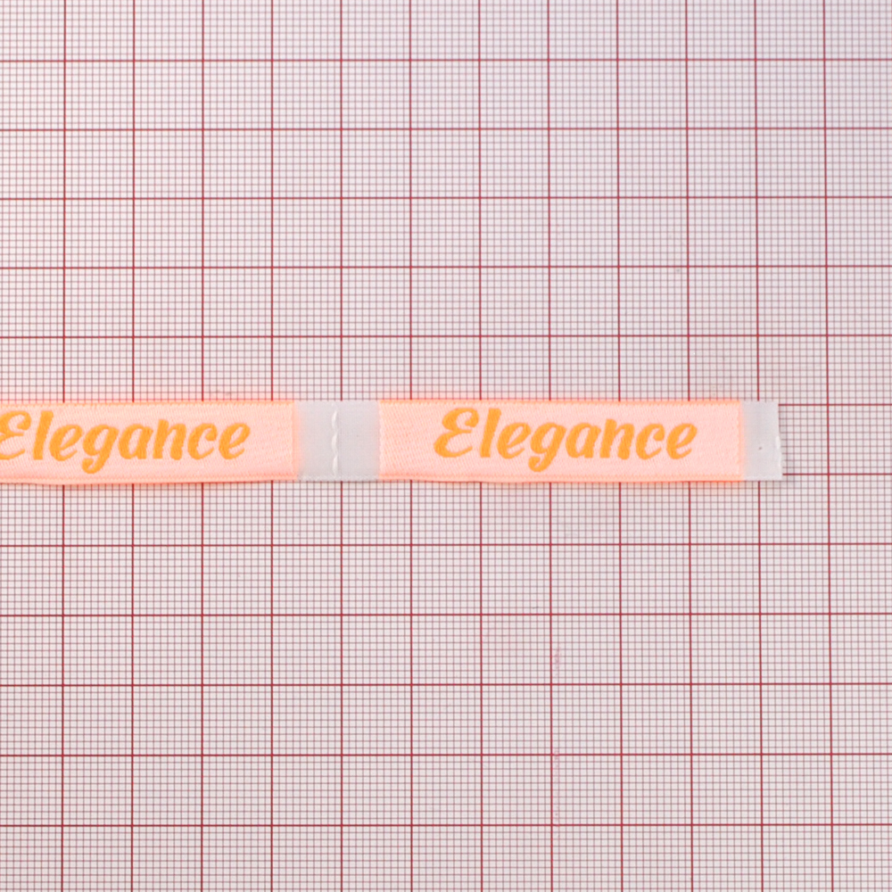 Этикетка тканевая вышивка Elegance №13, 1,2*6,6см белая, оранжевый лого /70 atki/ . Вышивка / этикетка тканевая