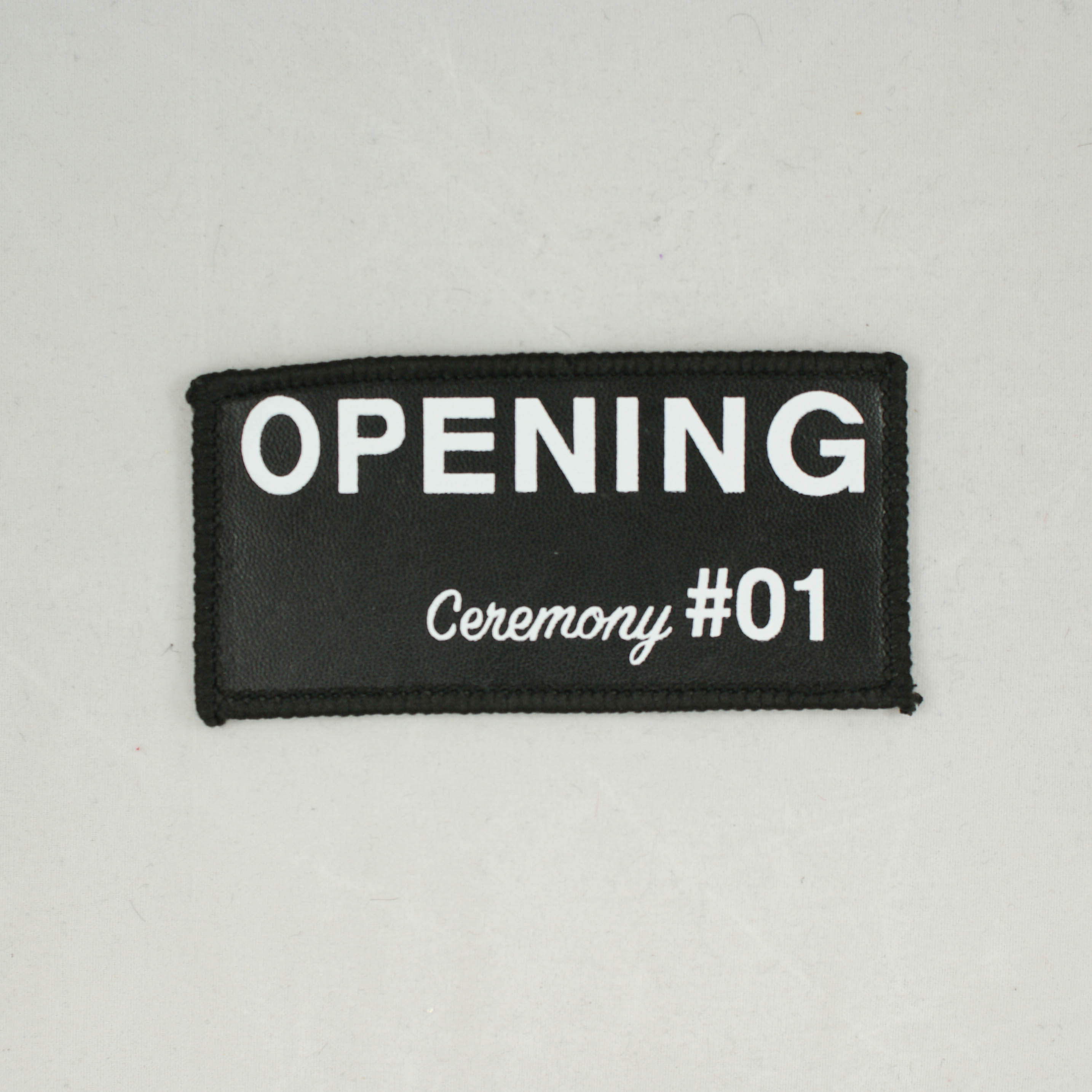 Нашивка кожзам Opening ceremony #01 5*10см, черный фон, белые буквы, черный оверлок, шт. Нашивка Кожзам