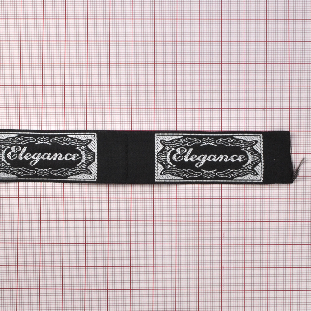 Этикетка тканевая вышитая Elegance № 1, 7,4*2,4см бел на черн /tafta/. Вышивка / этикетка тканевая