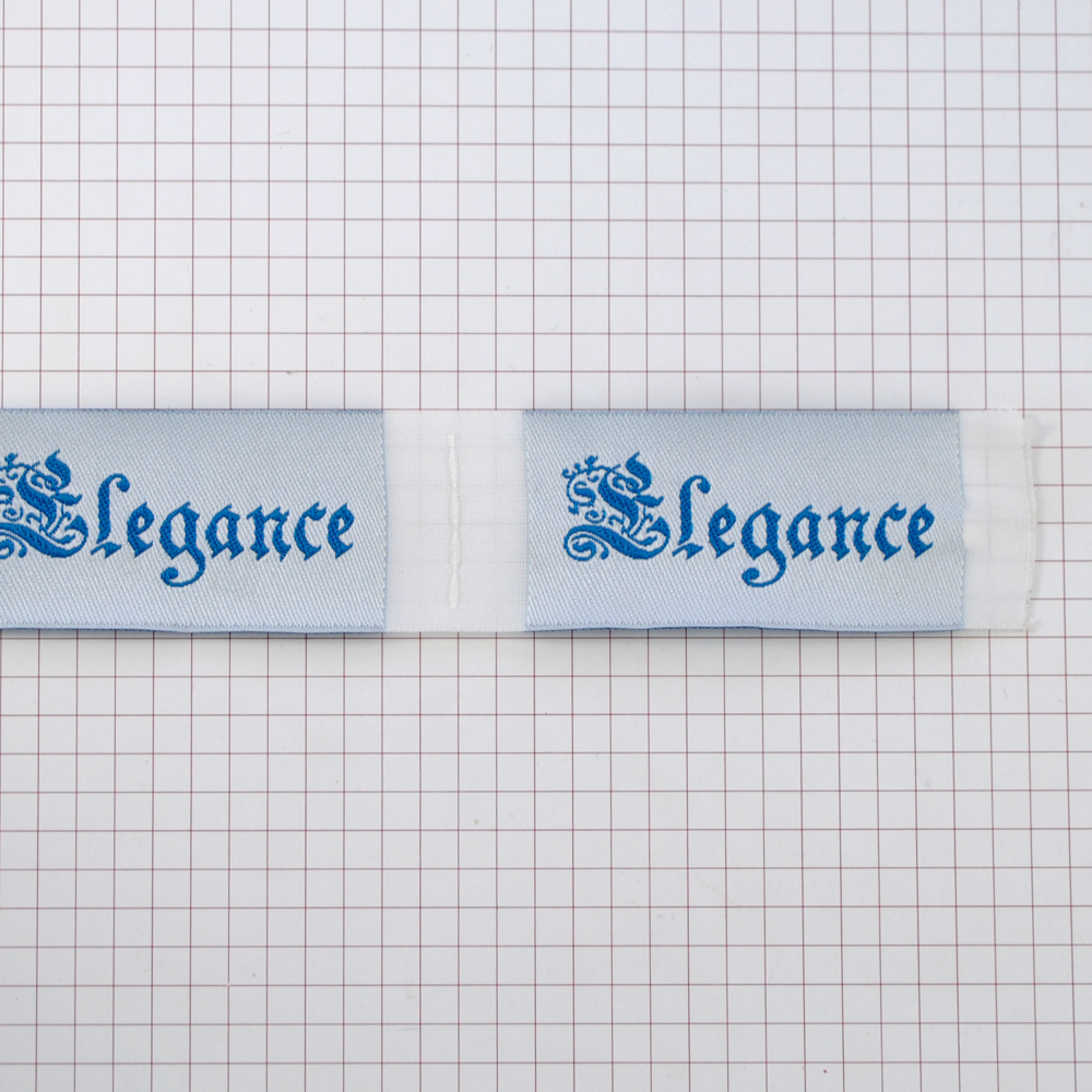 Этикетка тканевая вышитая Elegance №12 бело-голубой 3см. Вышивка / этикетка тканевая