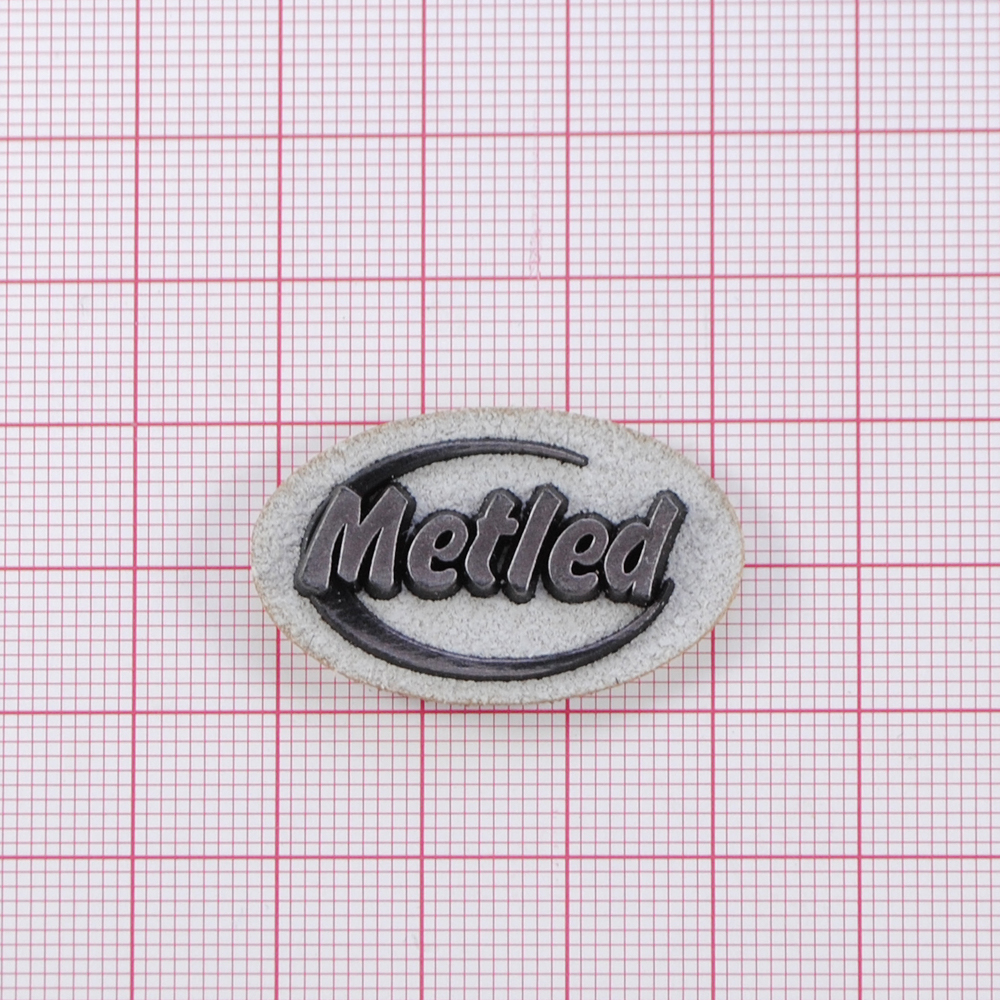 Лейба к/з Metled, 3,5*2см, овал, серый фон, напыление, шт. Лейба Кожзам